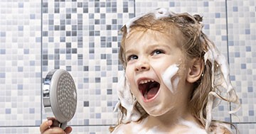 kid singing in the shower