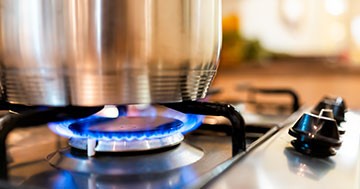 pot on natural gas stove with flame