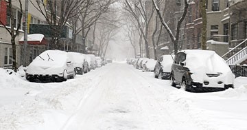 major snowstorm covering streets and cars