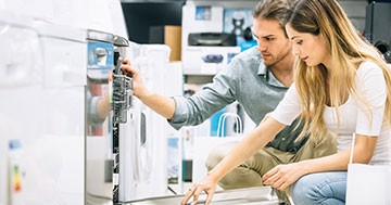 man and woman looking at appliances