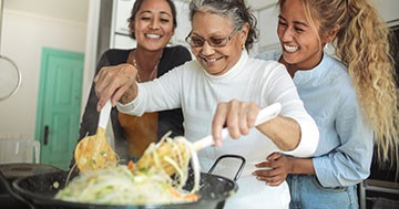 women around stove cooking