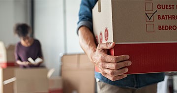 man and woman packing moving boxes