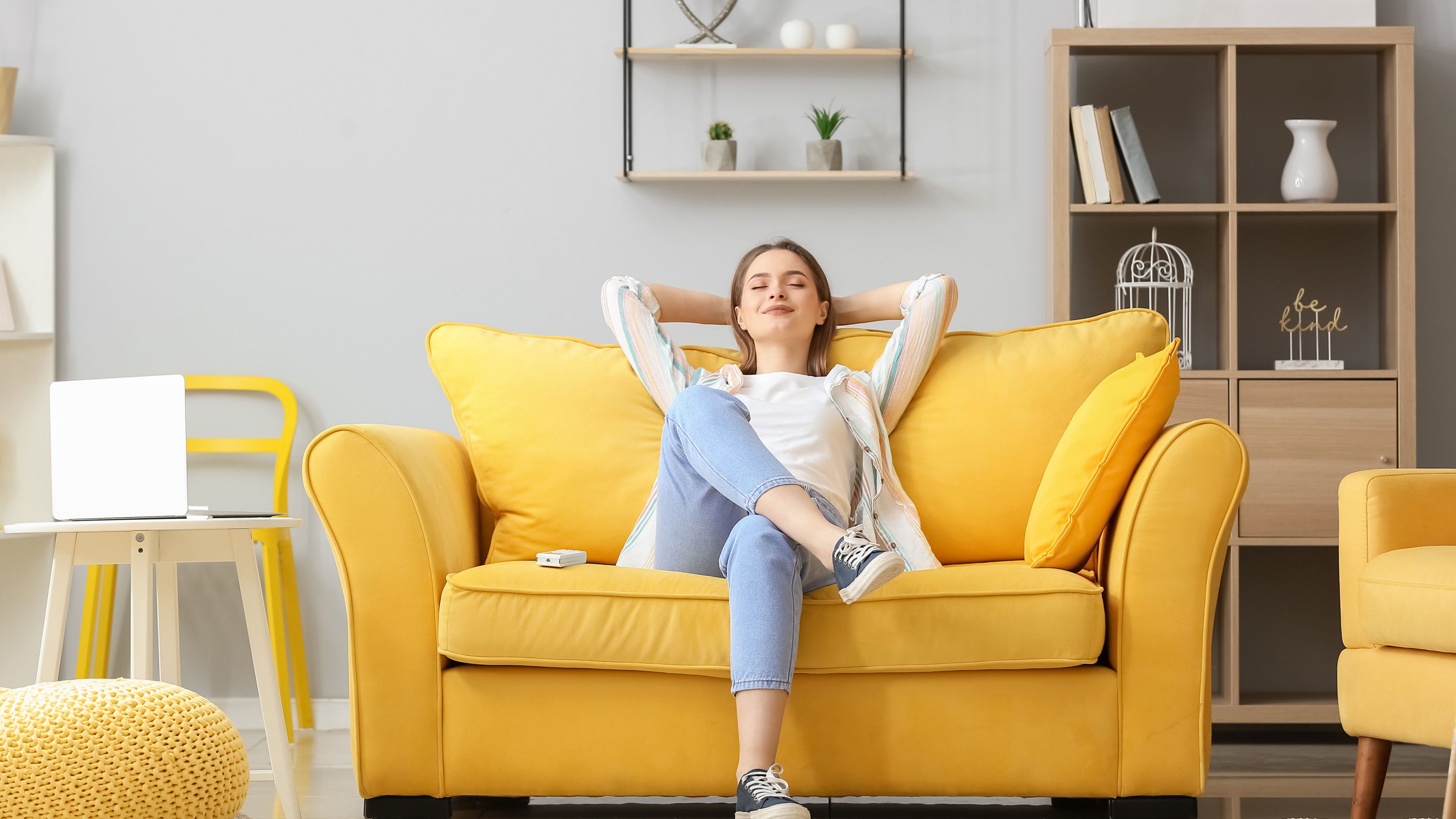 Beautiful young woman relaxing on sofa in living room